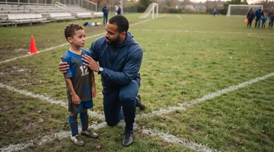 Soccer Coach Comforting Crying Young Player