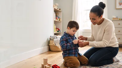 Mother Helping Young Son Button His Plaid Shirt