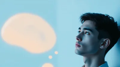 Young Man Looking At A Floating Thought Bubble
