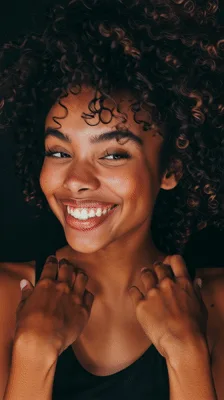 Happy Young Woman With Curly Hair Smiling At Camera