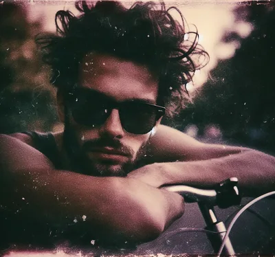 Young Man With Messy Hair Leaning On Bicycle