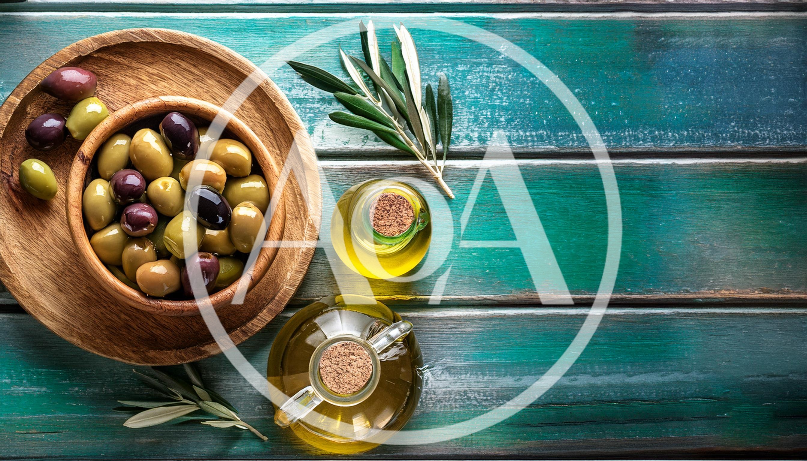 Wooden Bowl Of Olives And Olive Oil Bottles