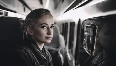 Young Woman Looking Out Train Window During Travel