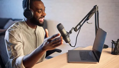 Black Podcaster Recording Audio Content In Home Studio