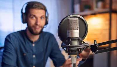 Podcaster Speaking Into A Professional Studio Microphone