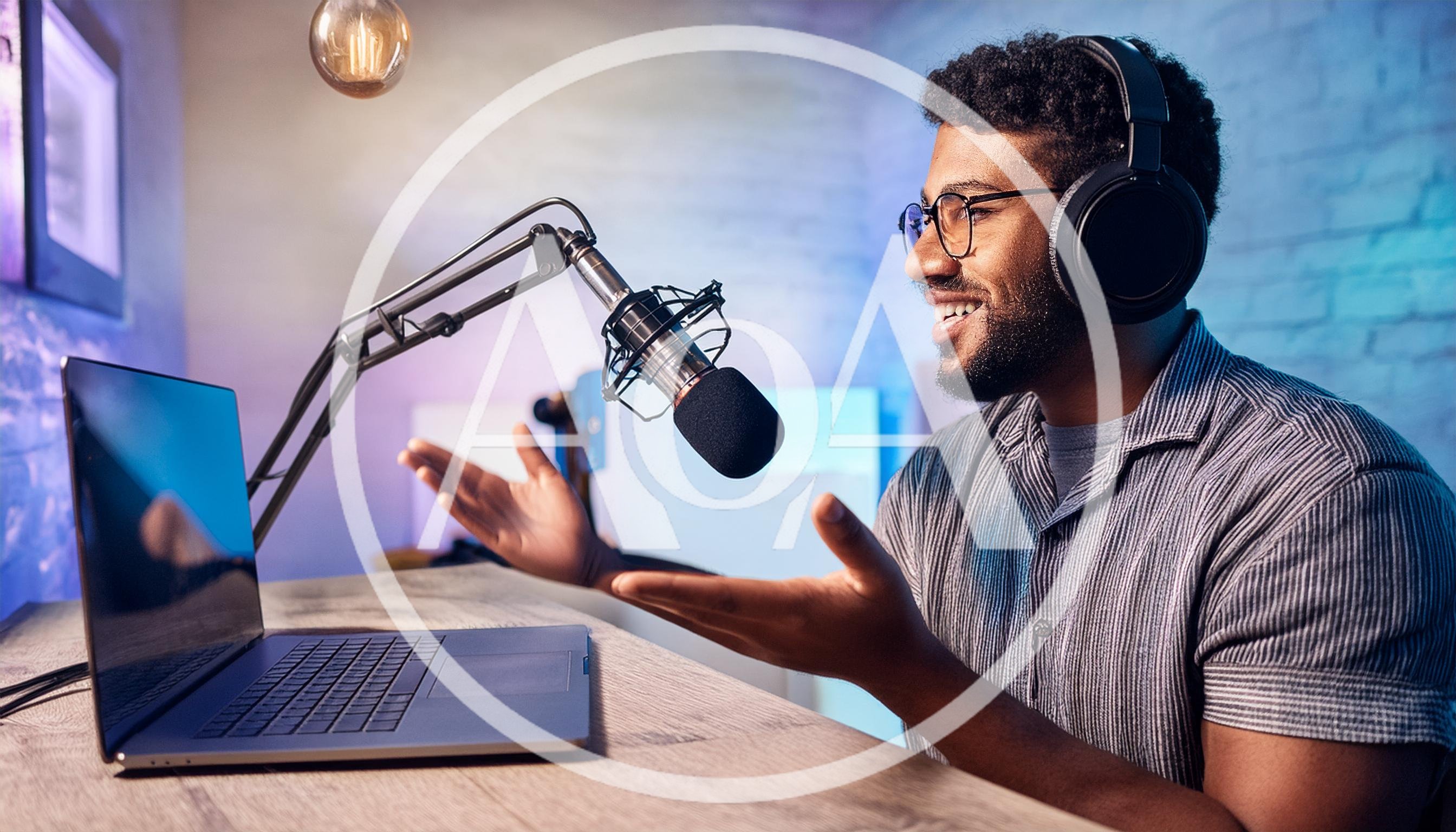 Young Man Recording Podcast In Home Studio