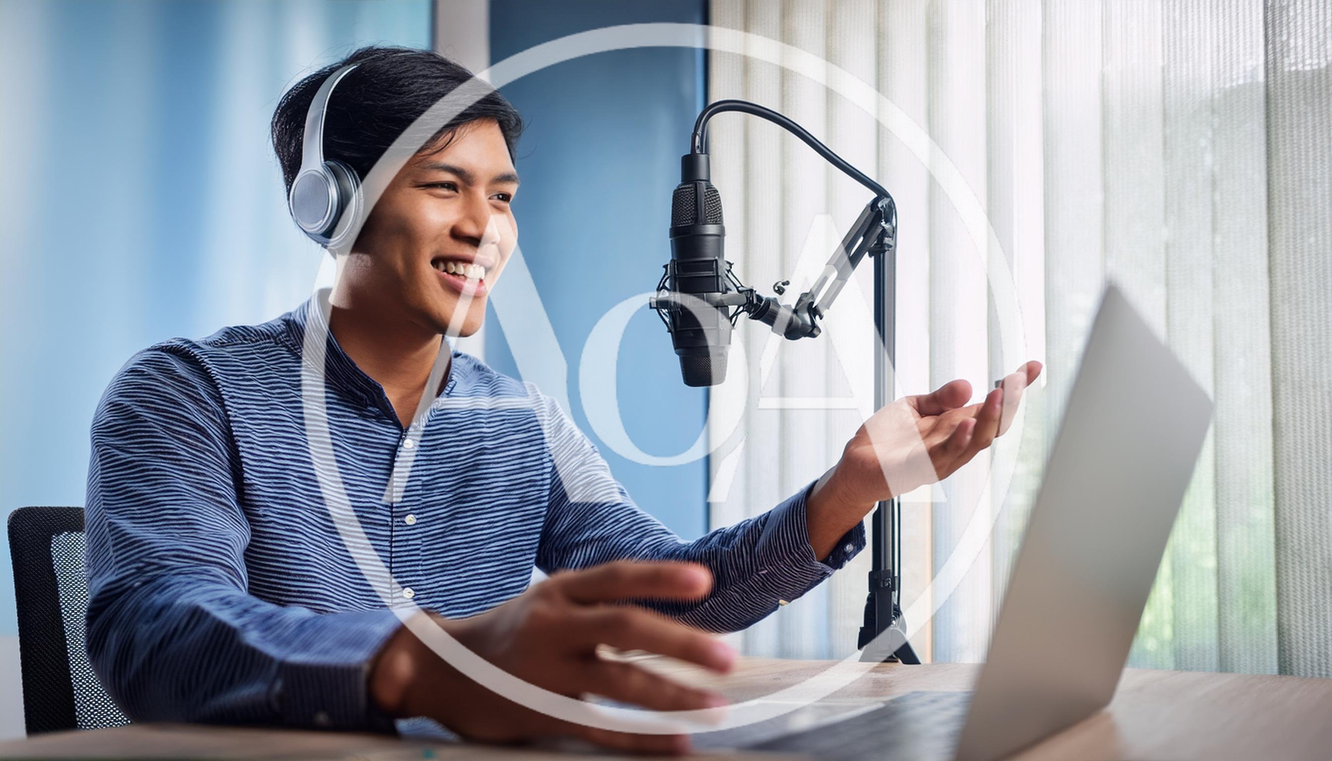 Young Man Recording Podcast With Laptop And Microphone