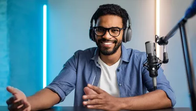 Smiling Podcaster Recording Audio In Studio