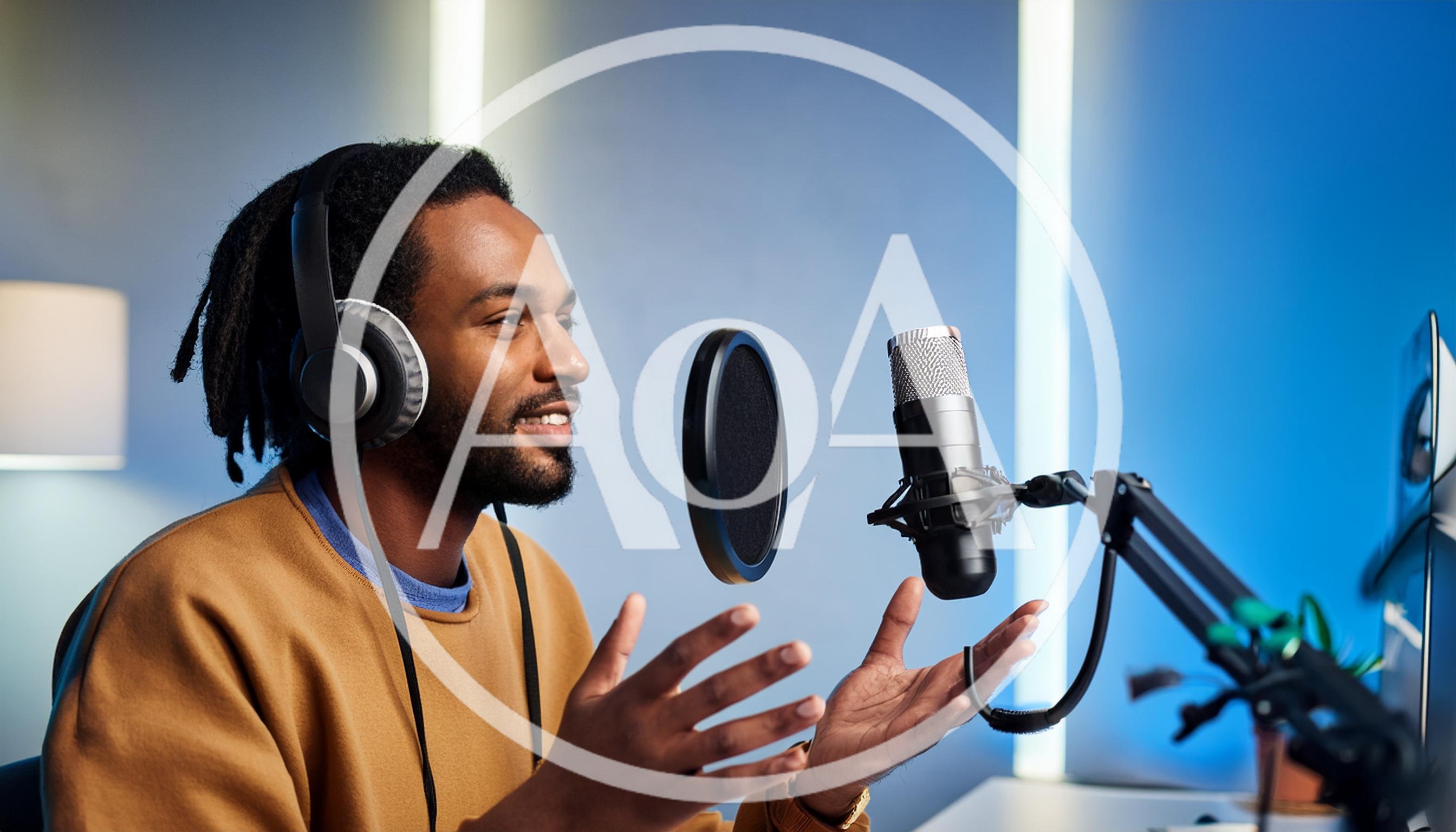 Young Man Recording Podcast In Home Studio