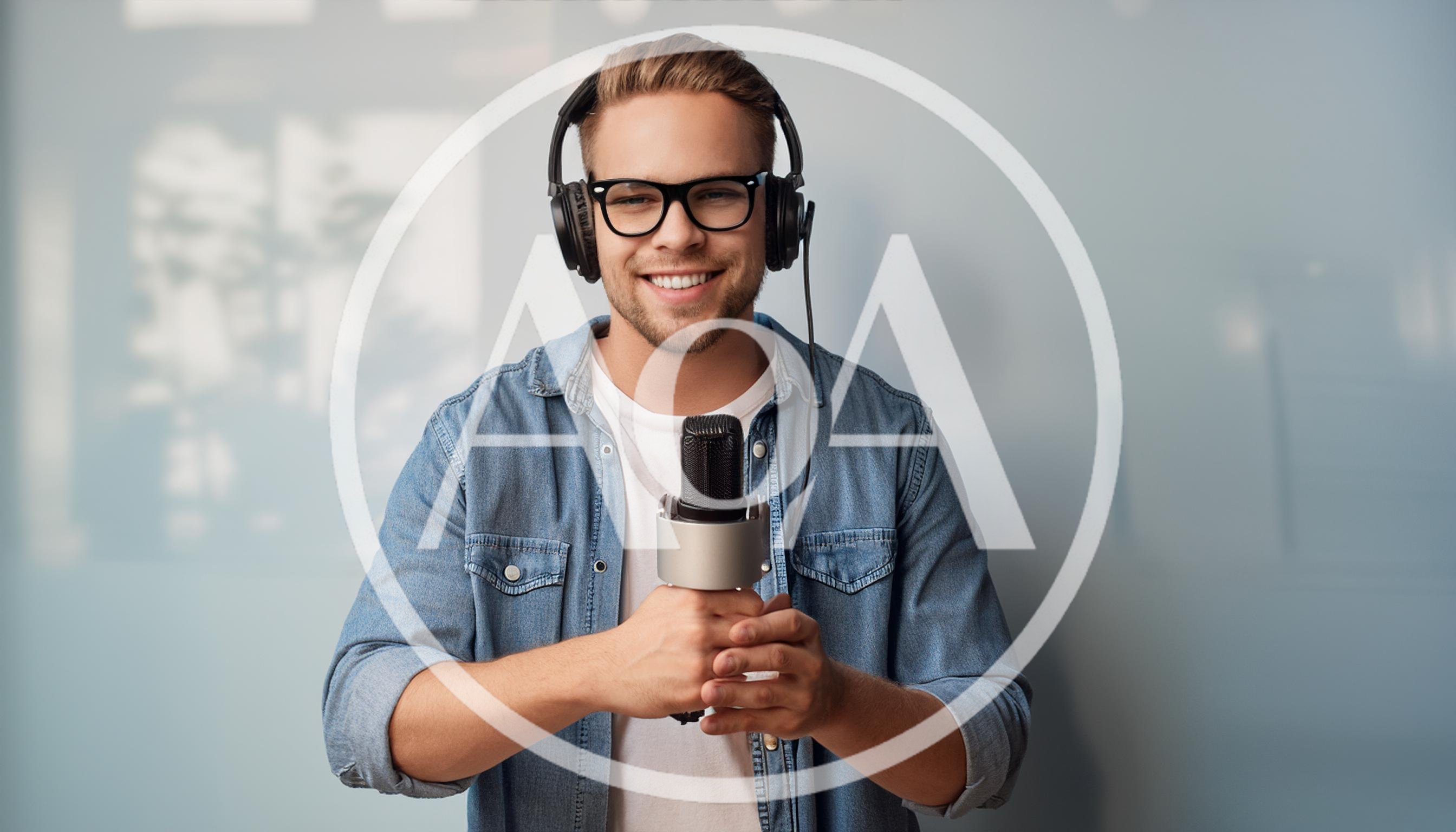 Young Man Wearing Headphones Holding A Microphone