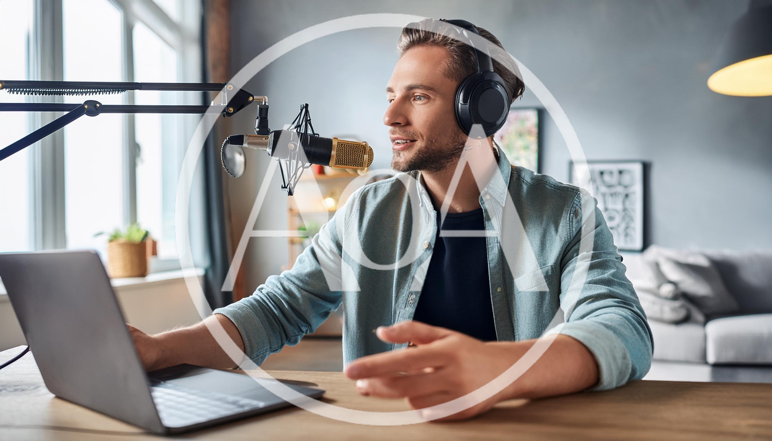 Young Man Recording Podcast In Home Studio