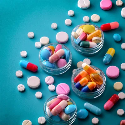 Assorted Pharmaceutical Pills and Capsules in Glass Bowls