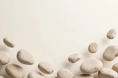 Floating Smooth Beige Pebbles On Minimalist Background