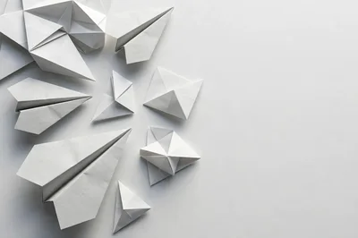 Collection Of White Paper Airplanes And Origami Shapes