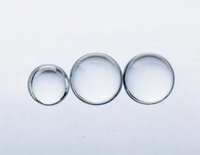 Three Transparent Water Droplets On A White Background