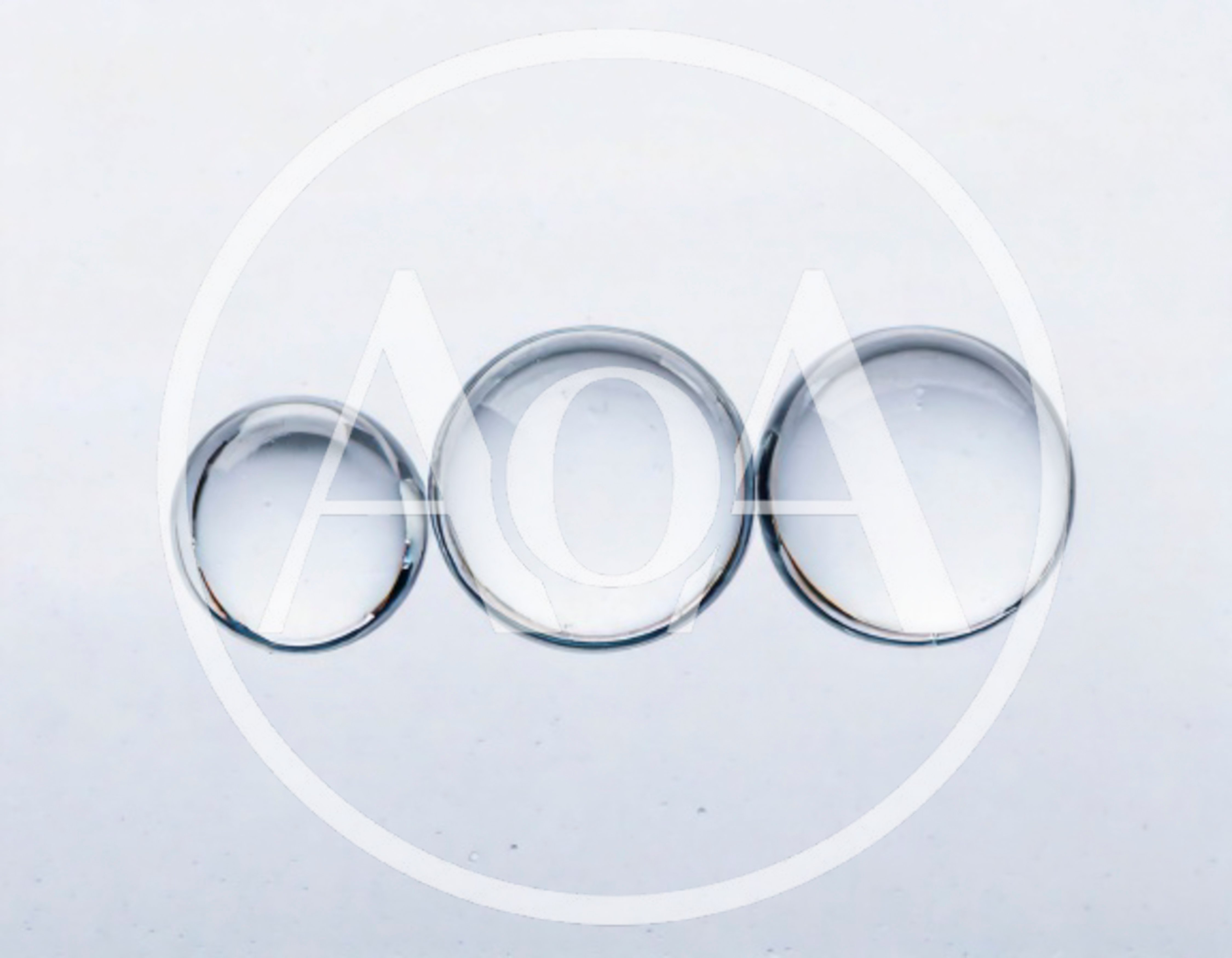 Three Transparent Water Droplets On A White Background