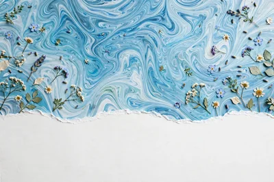 Pressed Wildflowers on Blue Marbled Paper Background