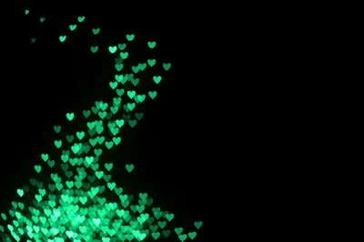 Green Heart Shaped Bokeh Lights On Black Background