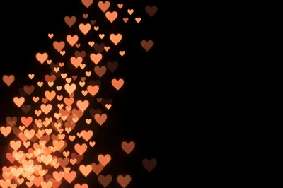Floating Glowing Orange Hearts On Black Background