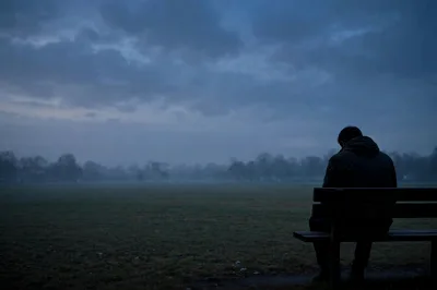 Lonely Man Sitting Alone On A Park Bench