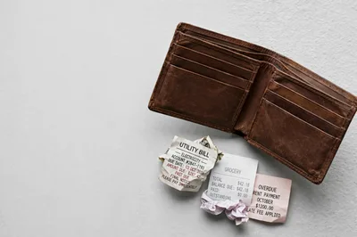 Empty Leather Wallet With Overdue Bills And Receipts