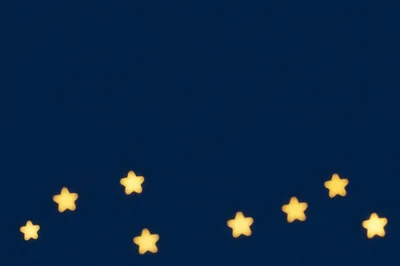 Blurred Star Shaped Bokeh Lights On Dark Blue Background