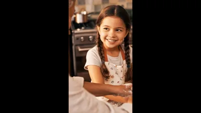Grandmother And Granddaughter Baking Cookies In Kitchen