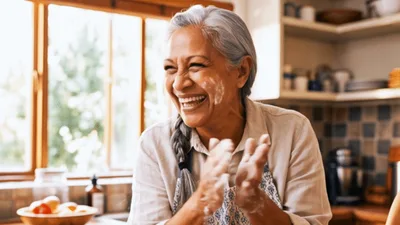 Happy Senior Woman Clapping Flour Off Her Hands