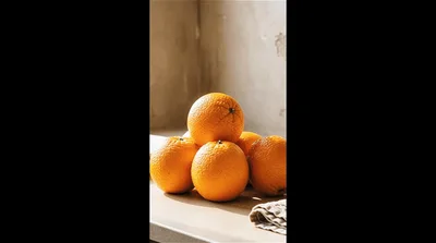 Stack Of Fresh Oranges On A Kitchen Counter