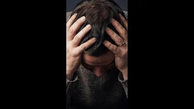 Stressed Man Holding Head in Hands