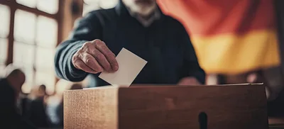 Elderly Man Casting Vote In Ballot Box