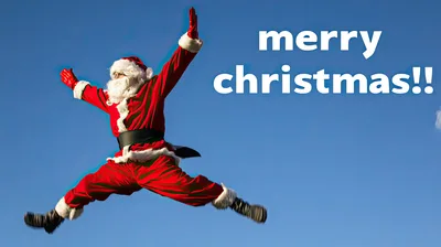 Santa Claus Jumping High Against A Clear Blue Sky