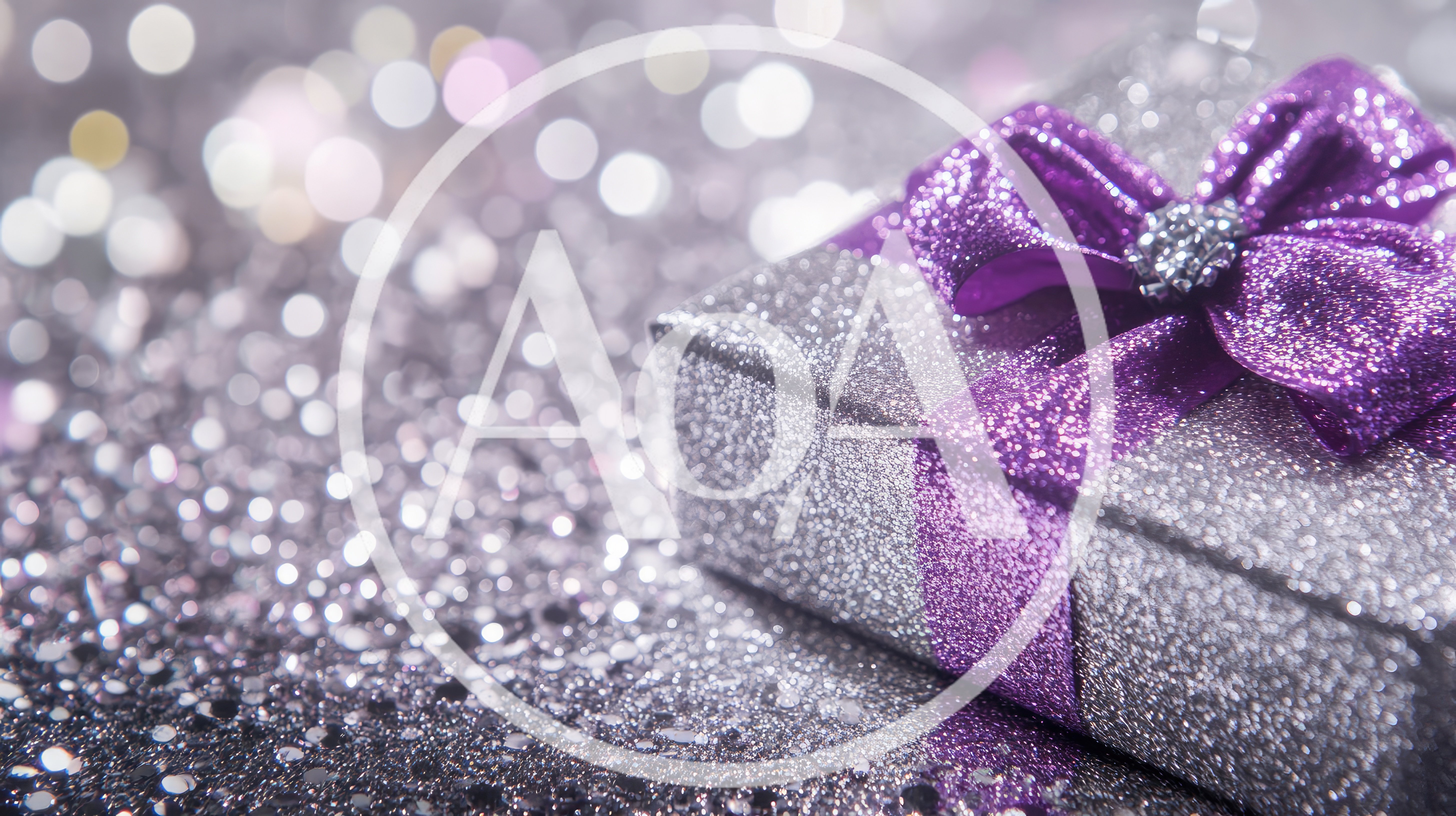 Silver Gift Box With Purple Ribbon On Glitter Background