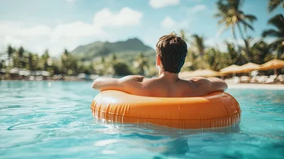Man Relaxing In An Orange Pool Float