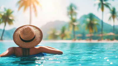 Woman Relaxing On Pool Float In Tropical Resort