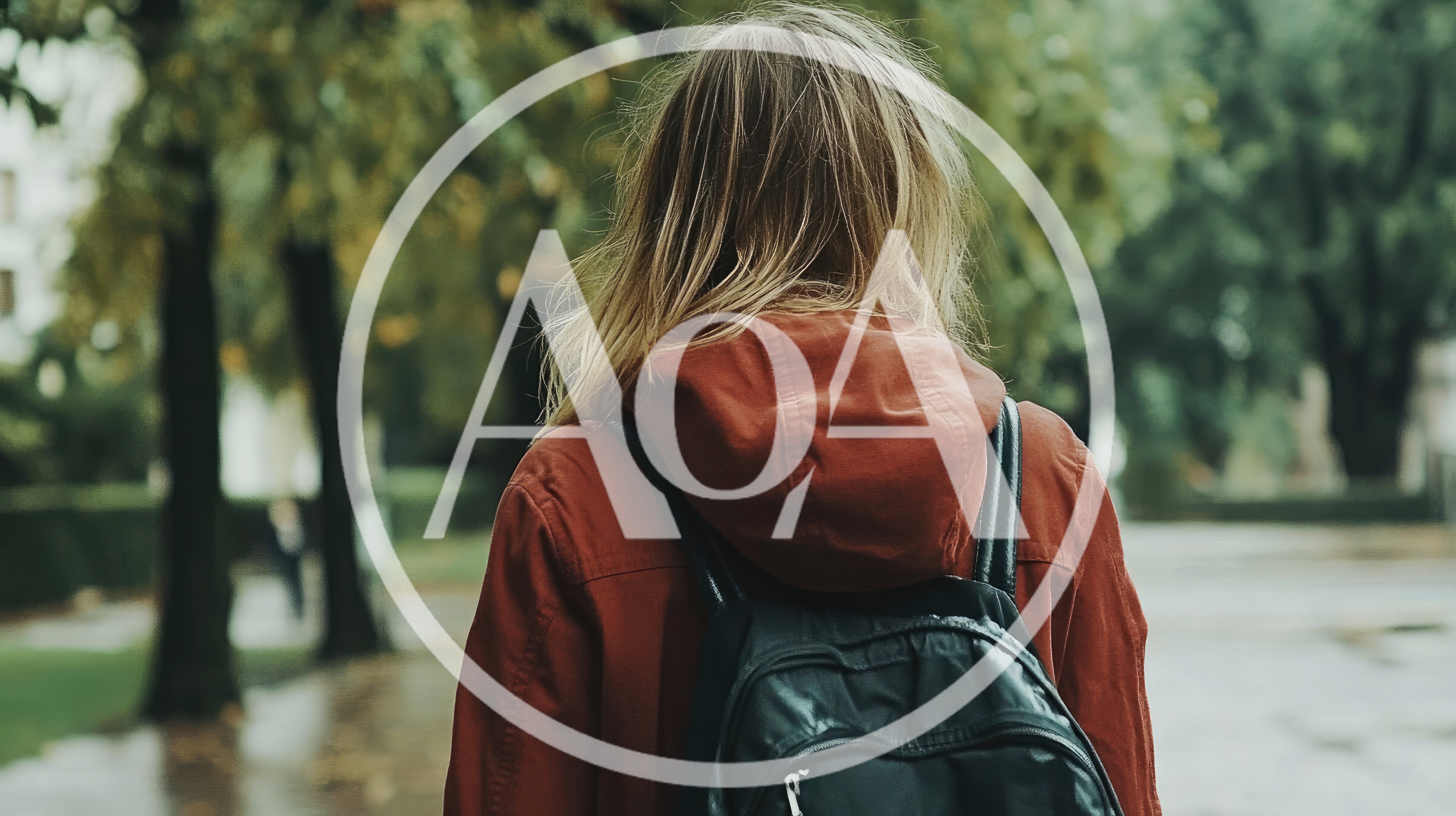 Young Woman Walking Through A Park In Autumn