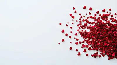 Red Heart Confetti Scattered on White Background