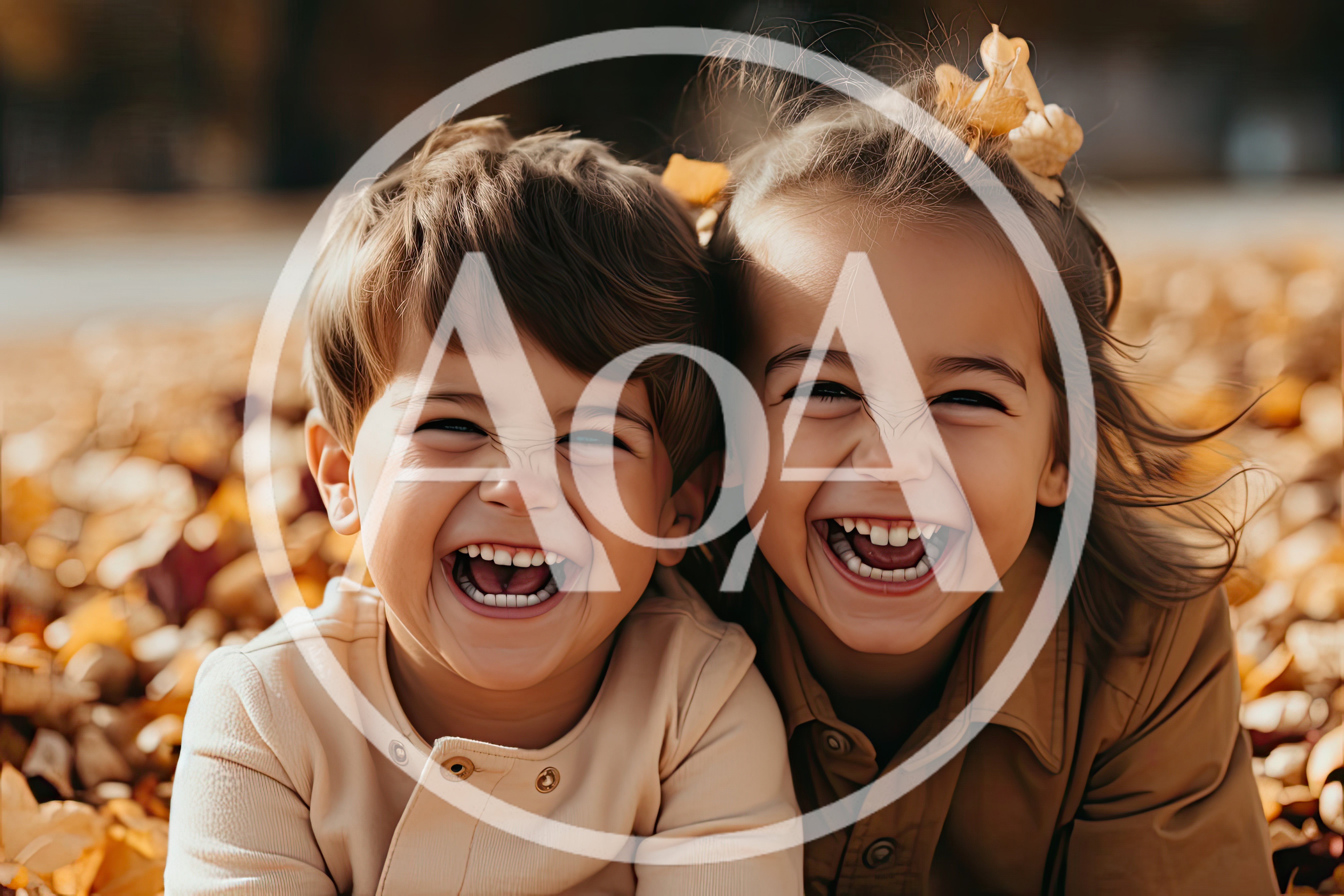 Two Happy Children Laughing Together In Autumn Leaves