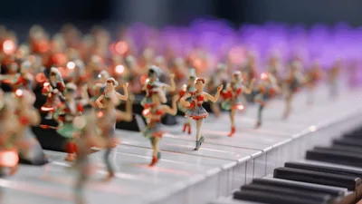 Miniature Ballerina Figurines Dancing On A Piano Keyboard