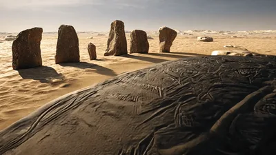 Ancient Stone Monoliths Standing In A Vast Desert Landscape