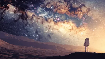 Astronaut Standing On Alien Planet Looking At Galaxy