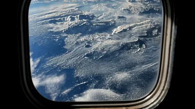 Aerial View of Earth Clouds from Airplane Window