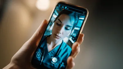 Person Having A Video Call With A Female Doctor