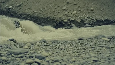 Turbulent River Water Flowing Over Rocky Riverbed