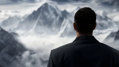 Businessman Standing On Snowy Mountain Peak Looking At Clouds