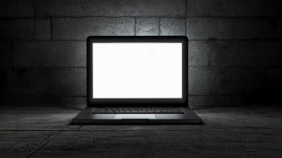 Laptop With Blank White Screen In Dark Room