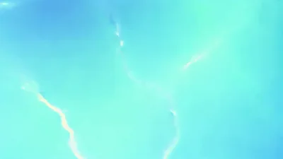 Bright Lightning Bolts Striking Across Dark Blue Night Sky