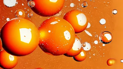 Floating Orange Spheres And Transparent Bubbles In Liquid