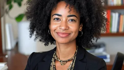 Professional Woman Smiling At Camera In Office Setting