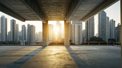 Sunlight Shining Through Concrete Pillars In Urban Cityscape